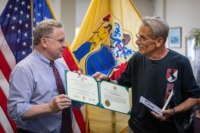 Vietnam War hero Bart Fabian (right) receives a Silver Star from Rep. Chris Smith