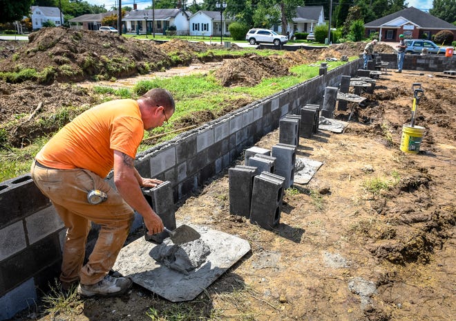 Laying block, Dallas Shock, Owensboro, with L.A. Buford Inc., helps build a foundation for a new home in the 800 Block Second development on Second Street in Henderson Tuesday, August 4, 2020.