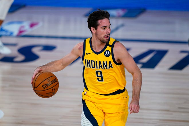 Indiana Pacers guard T.J. McConnell (9) plays against the Orlando Magic during the first half of an NBA basketball game Tuesday, Aug. 4, 2020 in Lake Buena Vista, Fla.