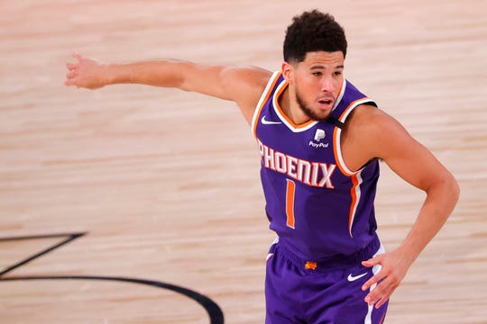Aug 4, 2020; Lake Buena Vista, USA; Devin Booker #1 of the Phoenix Suns celebrates after hitting a three point shot against the LA Clippers at The Arena at ESPN Wide World Of Sports Complex on August 04, 2020 in Lake Buena Vista, Florida. Mandatory Credit: Kevin C. Cox/Pool Photo via USA TODAY Sports