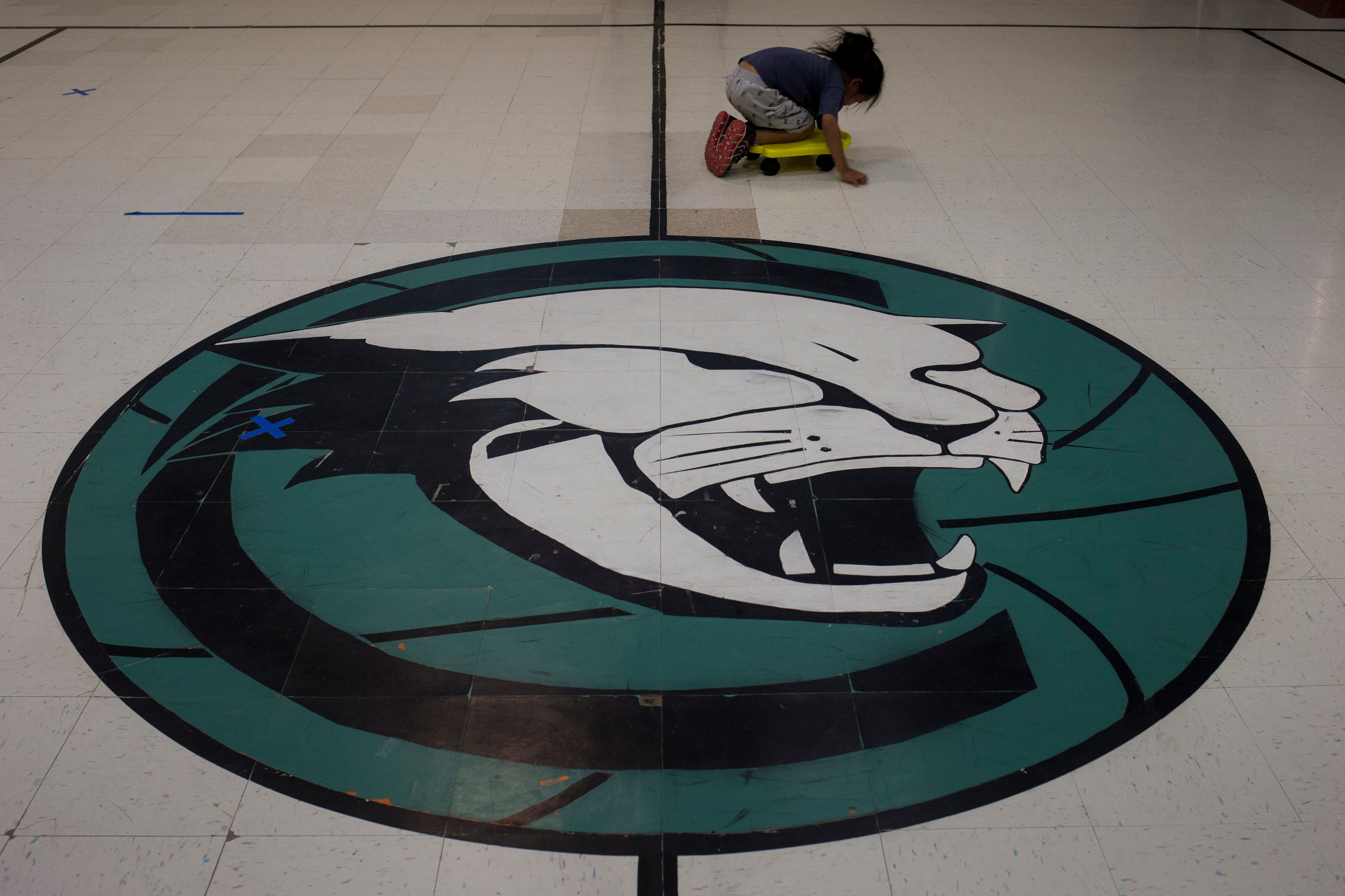 A kindergartner plays in the gym of Cove Day School, a school run by the BIE in Cove, Arizona, on the Navajo Nation.