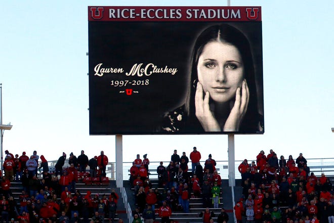 FILE - In this Nov. 10, 2018, file photo, a photograph of University of Utah student and track athlete Lauren McCluskey, who was fatally shot on campus, is projected on the video board before the start of an NCAA college football game between Oregon and Utah in Salt Lake City. An investigation found Wednesday, Aug. 5, 2020, that a group of University of Utah police officers made inappropriate comments about explicit photos of McCluskey, who had submitted the pictures as evidence in an extortion case shortly before her shooting death. The findings came after the Salt Lake Tribune unearthed allegations that an officer had bragged about having the images of McCluskey before her 2018 slaying. (AP Photo/Rick Bowmer, File)
