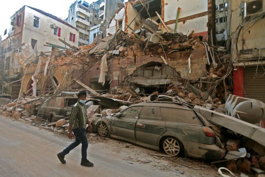 A cataclysmic explosion at a port in Beirut sowed devastation across entire neighborhoods, leaving a landscape of destroyed buildings and brick-covered cars.
