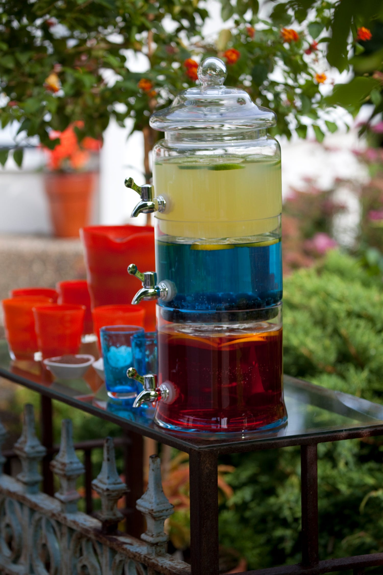 Entertaining during a pandemic is safest when held outdoors. Peggy Noe Stevens mixed batches of cocktails to help avoid multiple people touching the same bottles and mixers to make individual drinks.