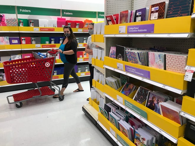 Shoppers peruse back-to-school items Aug. 5 at Target in Menomonee Falls. About 64% of 18,000 parents surveyed said they were not excited about back-to-school shopping this year because of health risks going into stores or risks to their children going back into classrooms, according to Piplsay, a crowdsourcing research firm.