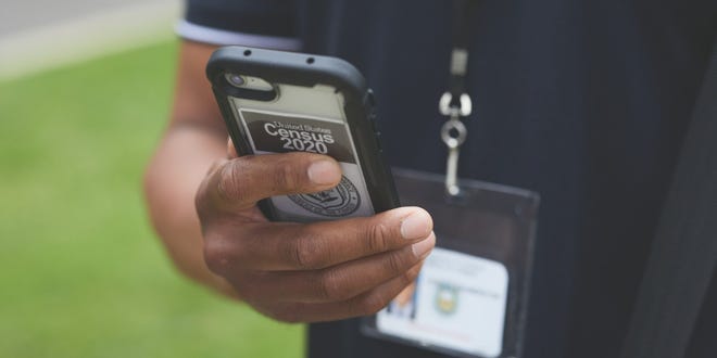 Census takers use devices issued by the Census Bureau to collect data.