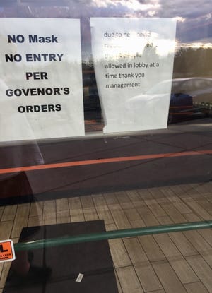 Sign on a Helena store warns people of the governor's mask order.