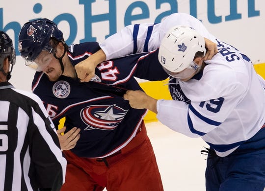 Toronto Maple Leafs center Jason Spezza (19) lands a punch on Columbus Blue Jackets defenseman Dean Kukan (46) during the second period.