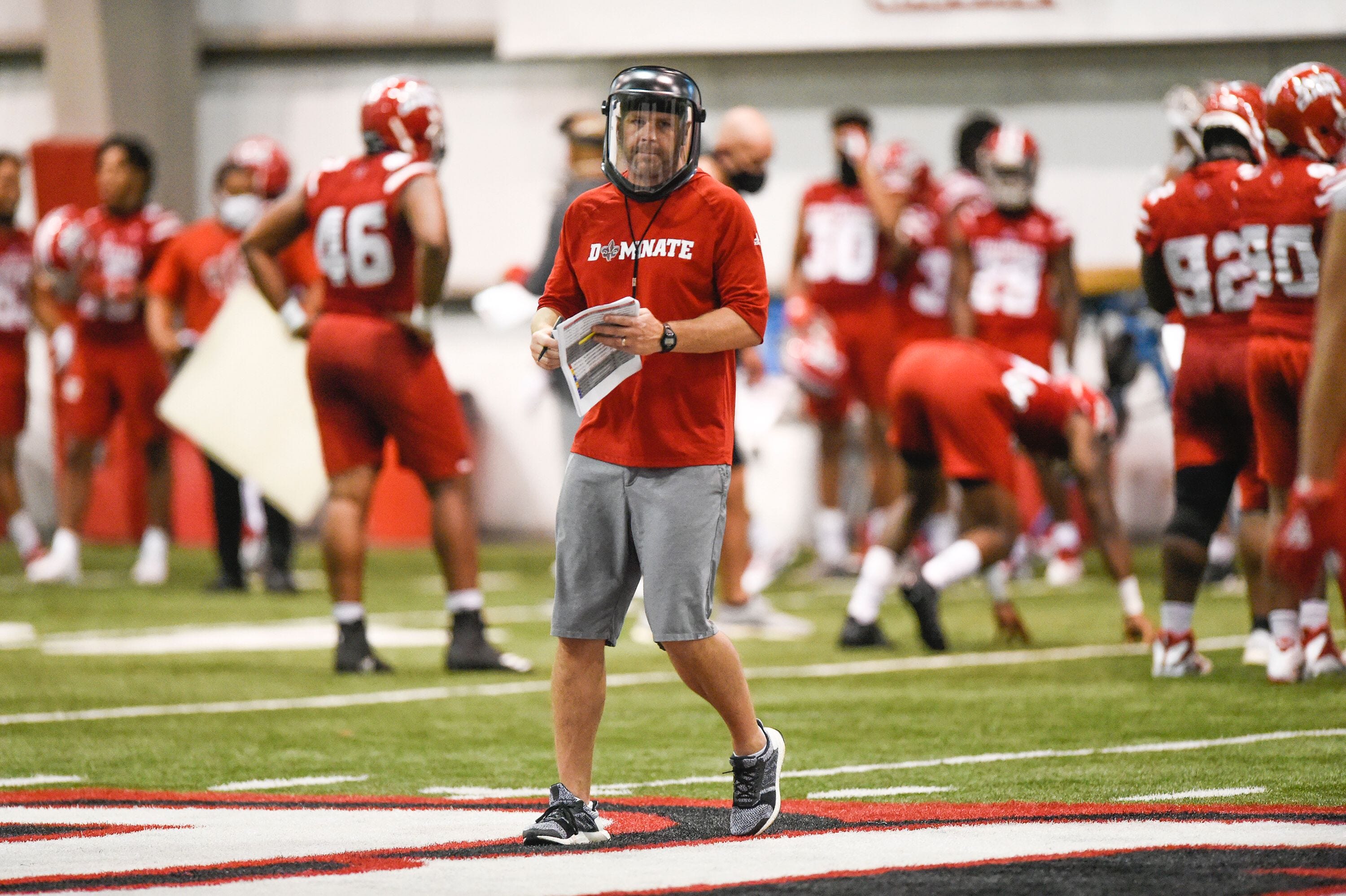UL coach Billy Napier was wearing a face shield to guard against the coronavirus (COVID-19) when preseason camp opened Friday.