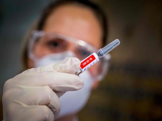 A nurse shows a COVID-19 vaccine produced by Chinese company Sinovac Biotech at the Sao Lucas Hospital, in Porto Alegre, southern Brazil on August 08, 2020. - The vaccine trial is being carried out in Brazil in partnership with Brazilian Research Institute Butanta. 