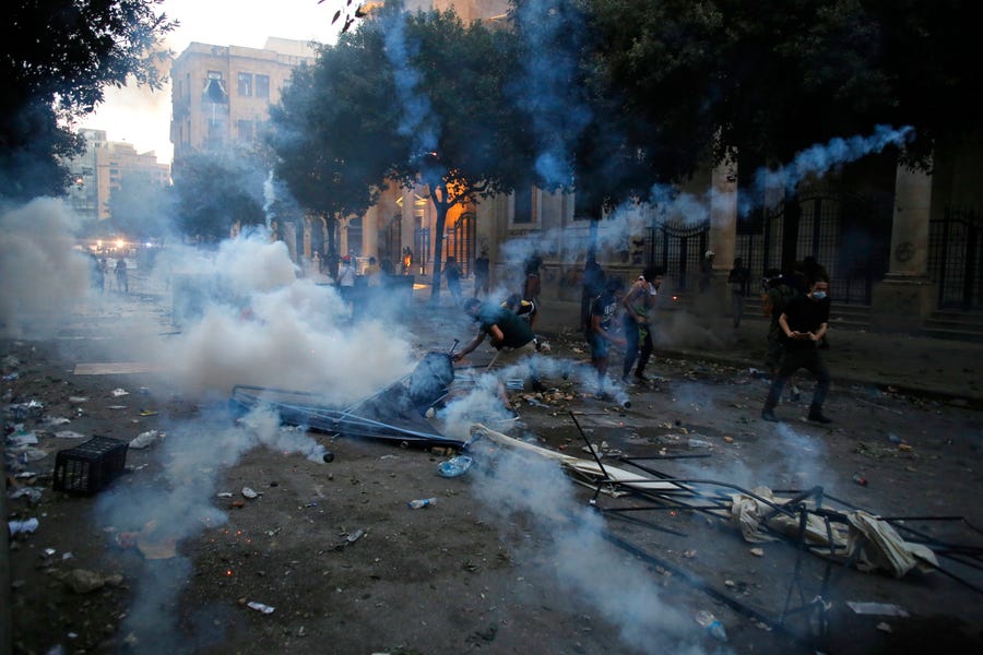 Protestors clash with police during a protest against the political elites and the government after this week's deadly explosion at Beirut port which devastated large parts of the capital in Beirut, Lebanon, Saturday, Aug. 8, 2020.