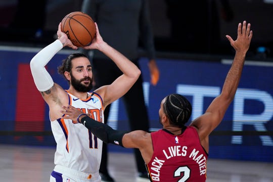 Aug 8, 2020; Lake Buena Vista, Florida, USA; Phoenix Suns' Ricky Rubio (11) looks to pass as Miami Heat guard Gabe Vincent (2) defends during the second half of an NBA basketball game at Visa Athletic Center. Mandatory Credit: Ashley Landis/Pool Photo-USA TODAY Sports