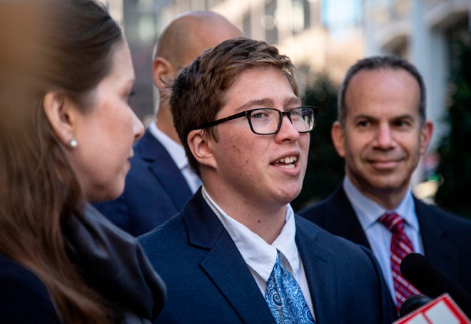FILE- In this Dec. 5, 2019, file photo, transgender student Drew Adams speaks with reporters in outside of the 11th Circuit Court of Appeals in Atlanta. A federal appeals court in 2019 said that the St. Johns County School District was wrong when it forced Adams to either use a girls or gender-neutral bathroom even though he identified as a boy.