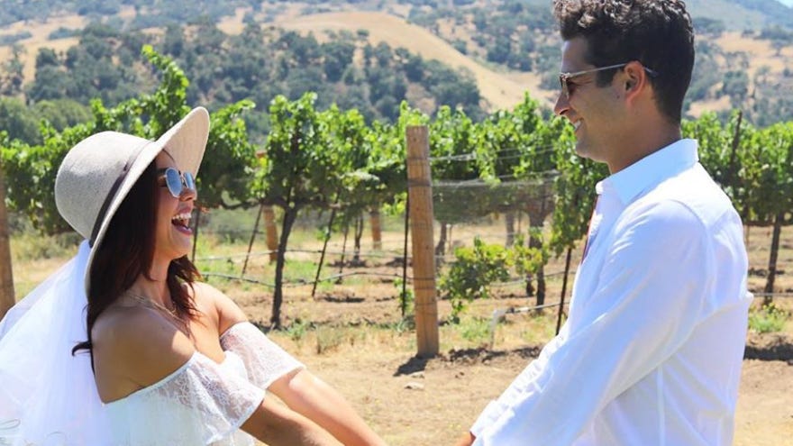 Sarah Hyland and Wells Adams celebrate their would-be wedding day wearing white, drinking wine - USA TODAY