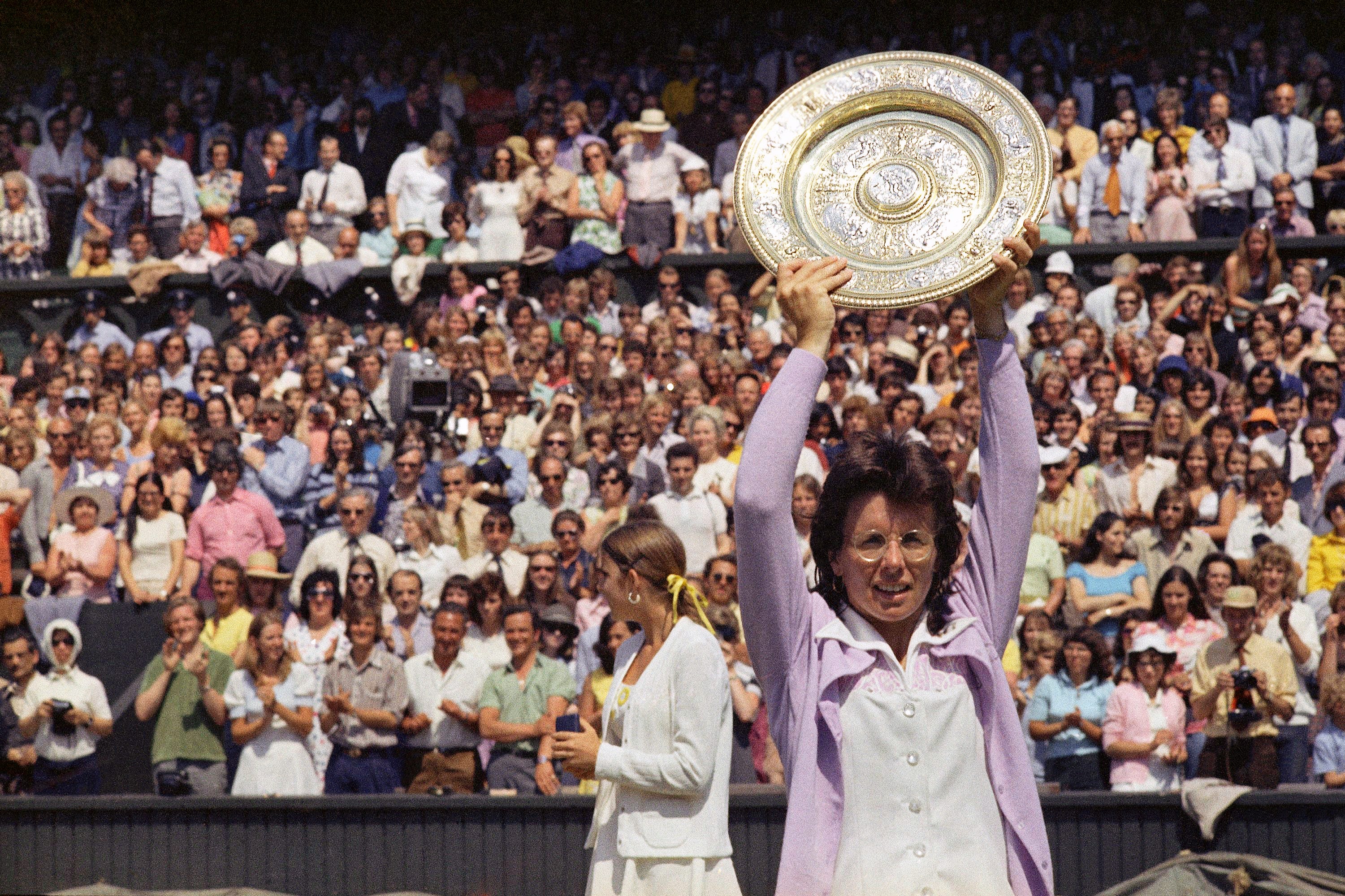 Billie Jean King holds up the championship trophy after defeating Chris Evert in the Wimbledon women's singles final in 1973. This was King's fifth time winning Wimbledon.