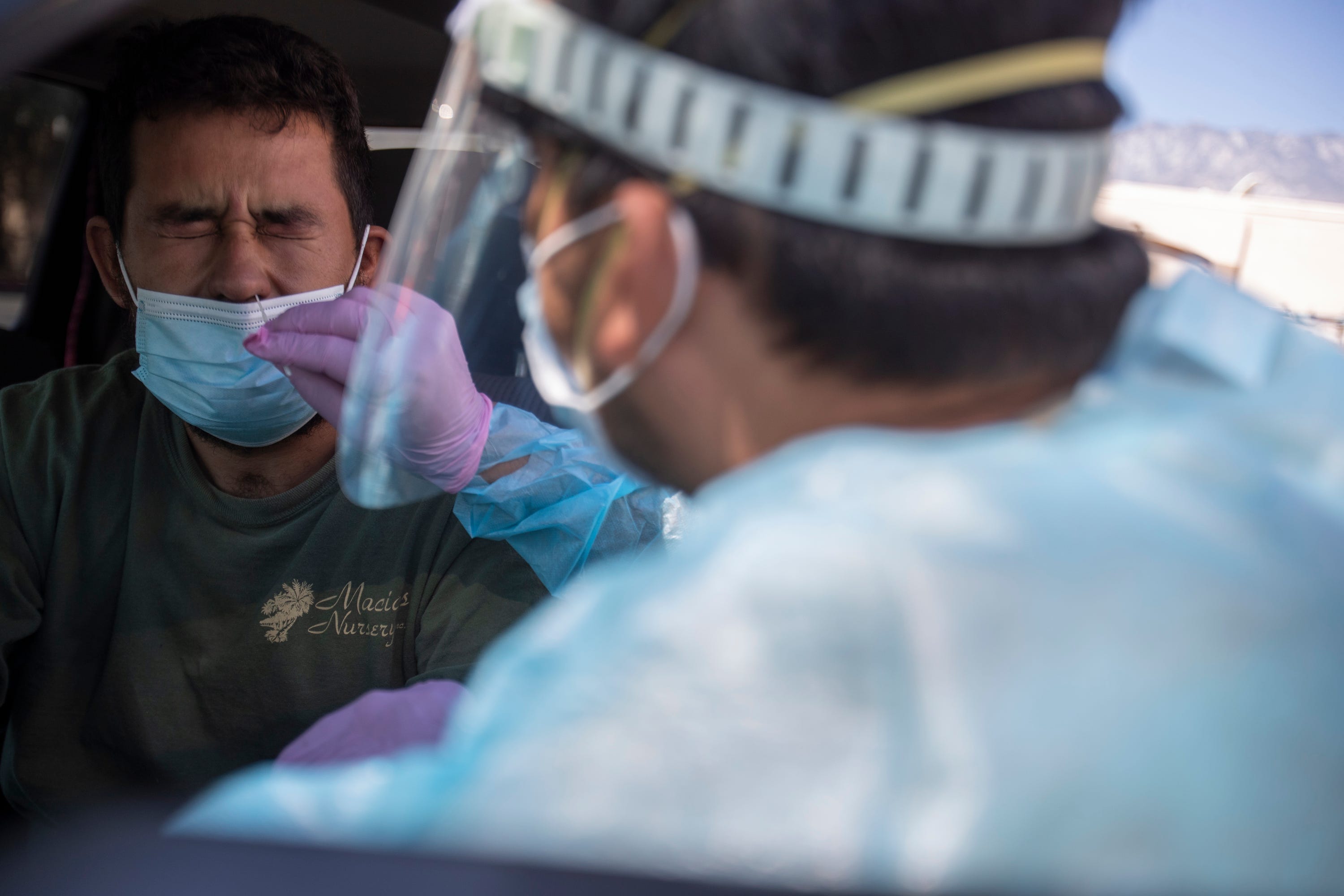 Jose Macias, LVN at Centro Medico Cathedral City, tests a resident for COVID-19 on July 30, 2020.