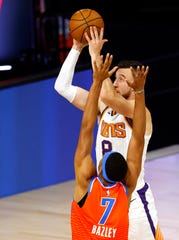 Phoenix Suns' Frank Kaminsky shoots as Oklahoma City Thunder's Darius Bazley defends during the first quarter of an NBA basketball game Monday, Aug. 10, 2020, in Lake Buena Vista, Fla. (Mike Ehrmann/Pool Photo via AP).