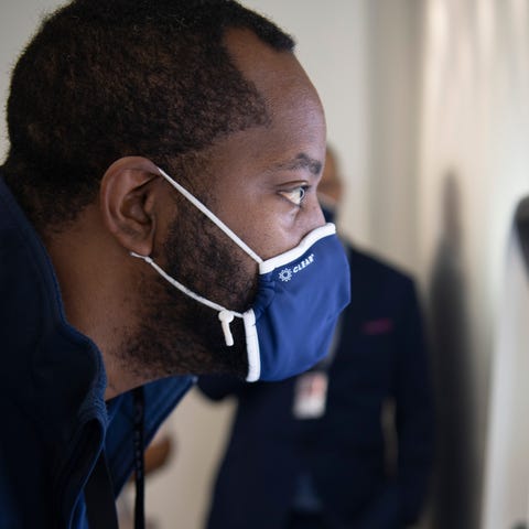 CLEAR employee Chris Pryor tests the eye scanner o