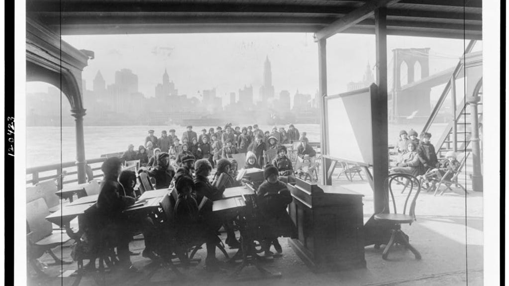 An Open Air Class on Day Camp Rutherford, a ferryboat, with New York City in background in 1911.
