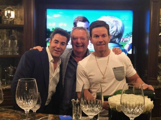 From left: Jay Feldman, restaurant owner Nino Cutraro and Mark Wahlberg gather for dinner at  Cutraro' Bella Piatti restaurant in Birmingham in August 2019. The three were celebrating opening a Wahlburgers restaurant in Royal Oak.