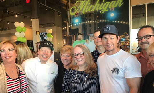 (From left) Chef Paul Wahlberg and Mark Wahlberg celebrated the grand opening of the Flint Wahlburgers in July 2019.   Jay Feldman is a partner in the restaurant.