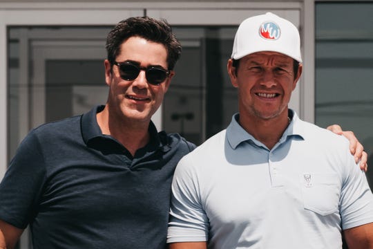 Finding time for a good game of golf is a part of most visits between Jay Feldman (left) and Mark Wahlberg (right). Feldman doesn't golf but he accompanies Wahlberg, an avid golfer.