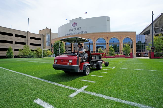 A University of Wisconsin-Madison sports turf manager works on the north practice field used for football practice across from Camp Randall Stadium on the University of Wisconsin-Madison campus in Madison on Thursday, Aug. 13, 2020. Big Ten league officials announced this weeks football and all other fall sports will be shut down and moved to the second semester of the 2020-21 academic year because of ongoing concerns about the COVID-19 pandemic.