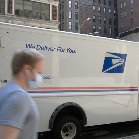 A United States Postal Service (USPS) truck is par