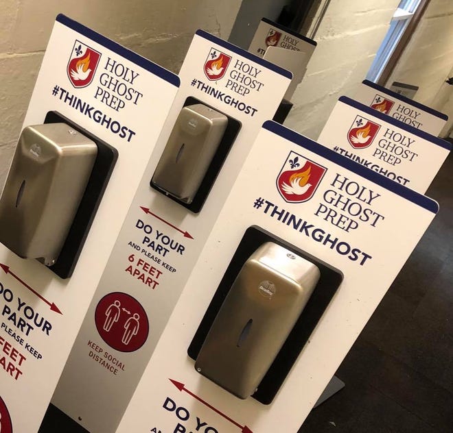Personalized hand sanitizing dispensers are waiting to be installed at Holy Ghost Preparatory School in Bensalem. [photo: COURTESY HOLY GHOST PREPARATORY SCHOOL]