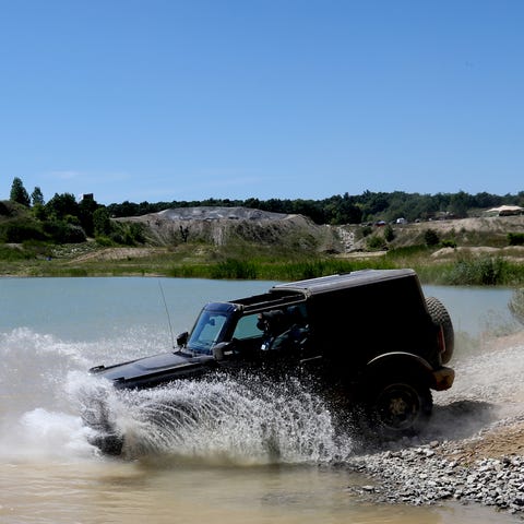 A 2021 Ford Bronco two-door goes through water dur