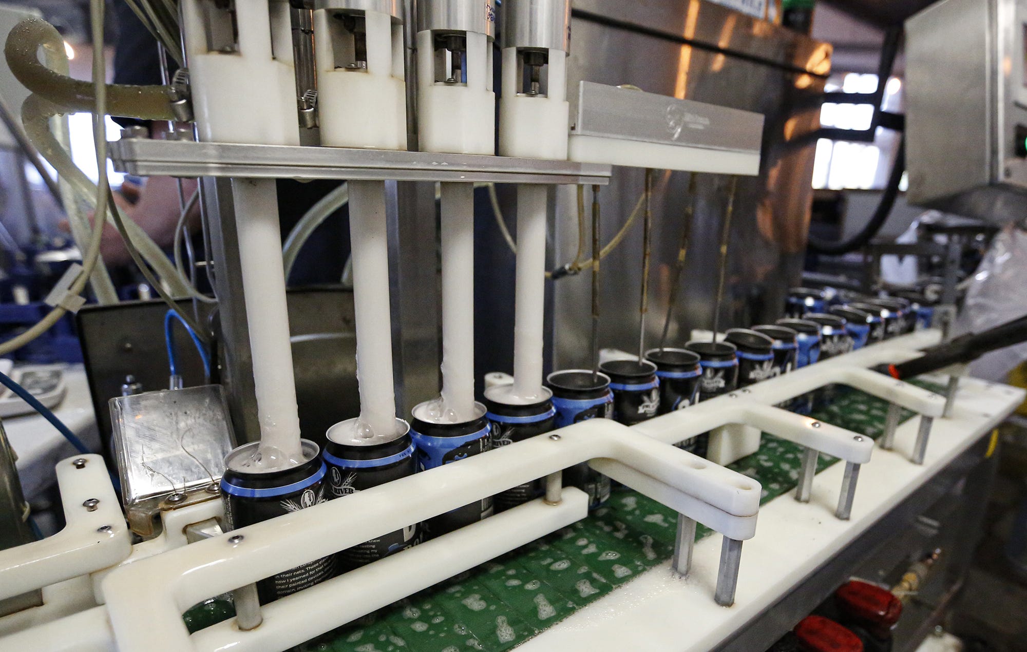 Blu Bobber beer cans are filled at Fox River Brewing co. in Oshkosh by Midwest Mobile Canning, a Chicago company that serves breweries in seven states in the Midwest.