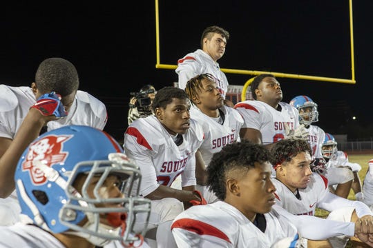 South Mountain High School  team listen to their coaches after winning the game against Central High School.