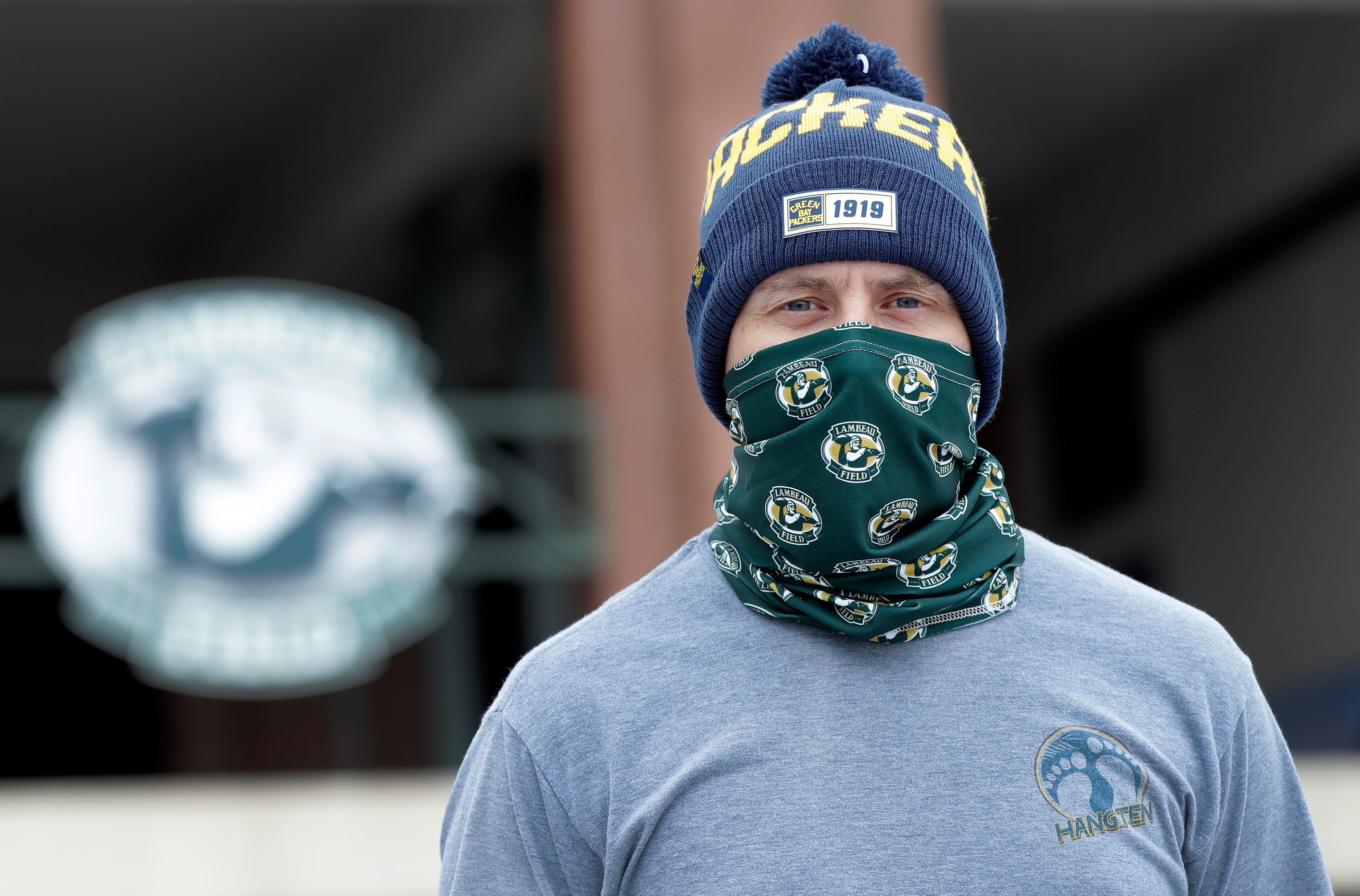 Jason Apfel of Gordon, Wis. wears his newly purchased Green Bay Packers hat and face covering outside Lambeau Field on Aug. 15, 2020, in Green Bay, Wis. The Green Bay Packers held their first practice of training camp at Ray Nitschke Field, but with no public viewing due to the coronavirus pandemic, only a few fans visited the area.