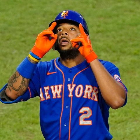 New York Mets' Dominic Smith reacts after hitting 