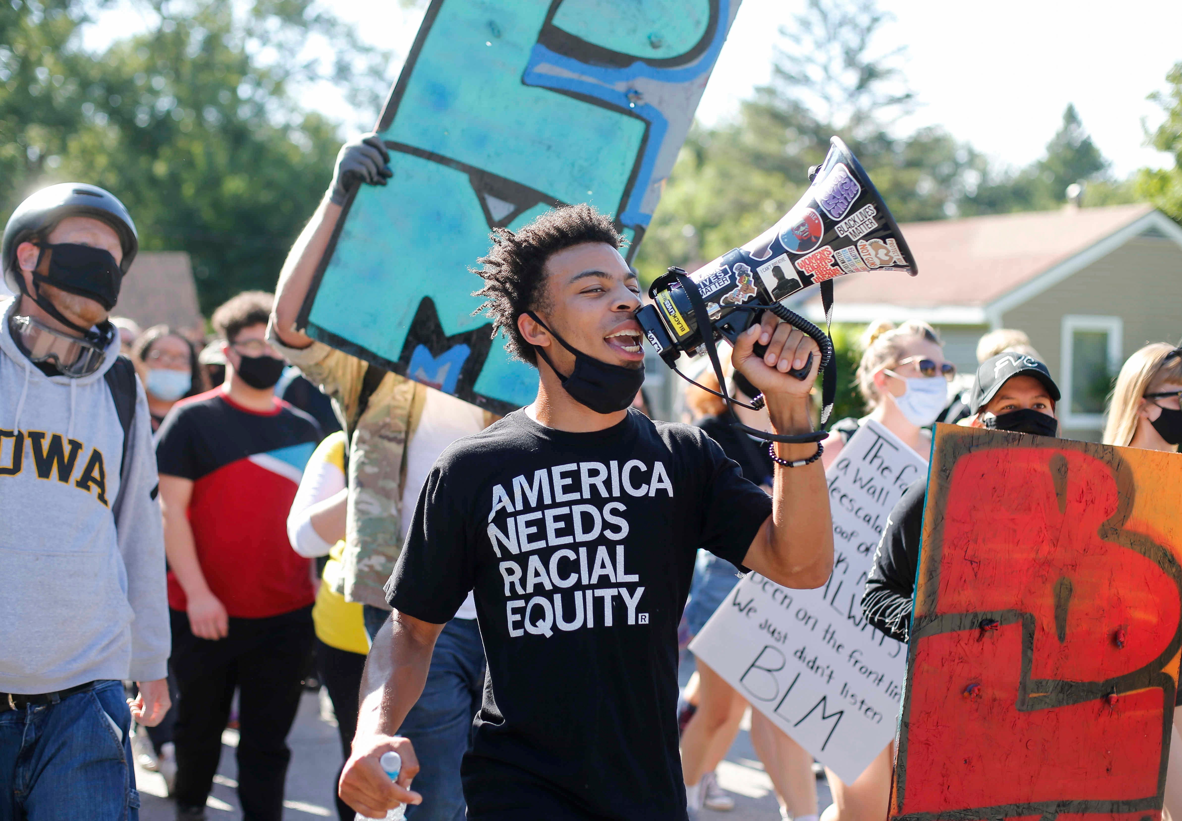 Matthew Bruce leads protesters with BLM Des Moines in a march in on Saturday, Aug. 15, 2020, to a home owned by Des Moines City Councilman Joe Gatto to vocalize a list of demands.