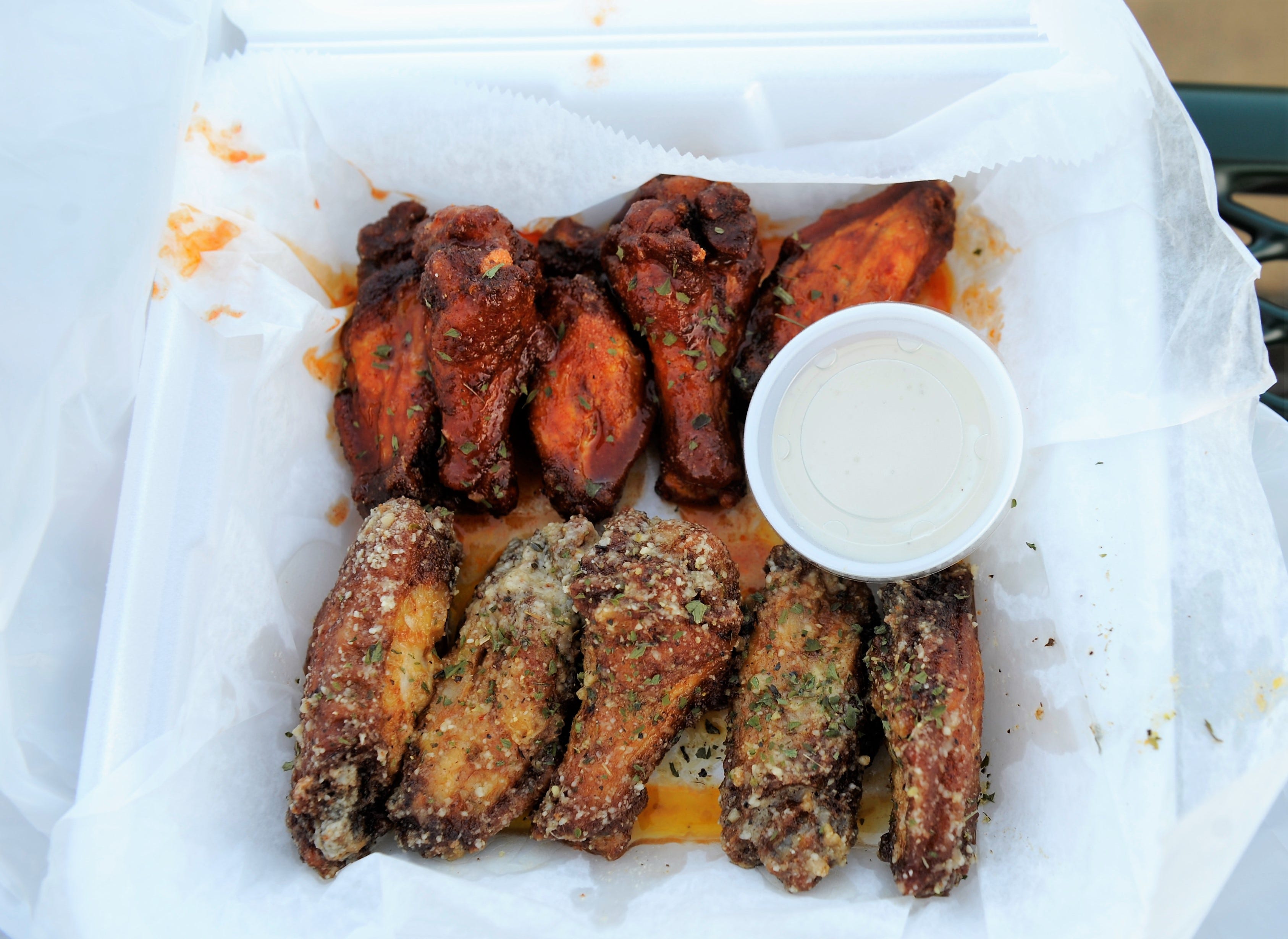 Wings with Nashville Hot and Garlic Parmesan sauce from the Trappin' Chick'n food truck on Thursday, Aug. 20, 2020.