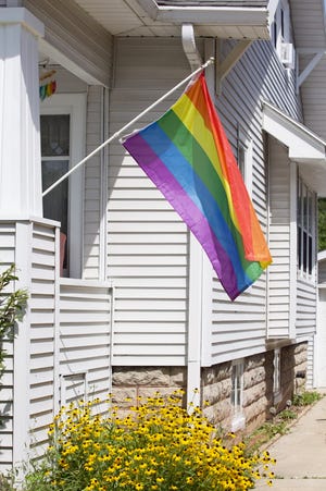 A rainbow LGBTQ flag flies outside the residence of Christine Anderson and Brad Peck, the subject of anonymous homophobic threats.