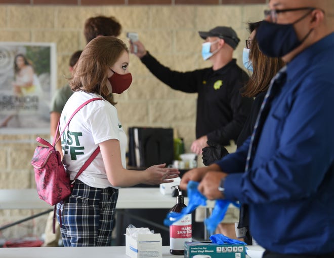 Bishop Manogue students temperatures are scanned and students sanitize as they enter on the first day back to school amid the COVID Pandemic on Monday August 17, 2020