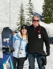 Alex Neal, 21, snowboards with her father, Mark David Neal, 62, in January. Her father died as a result of the coronavirus in April after a five-week struggle with the disease.
