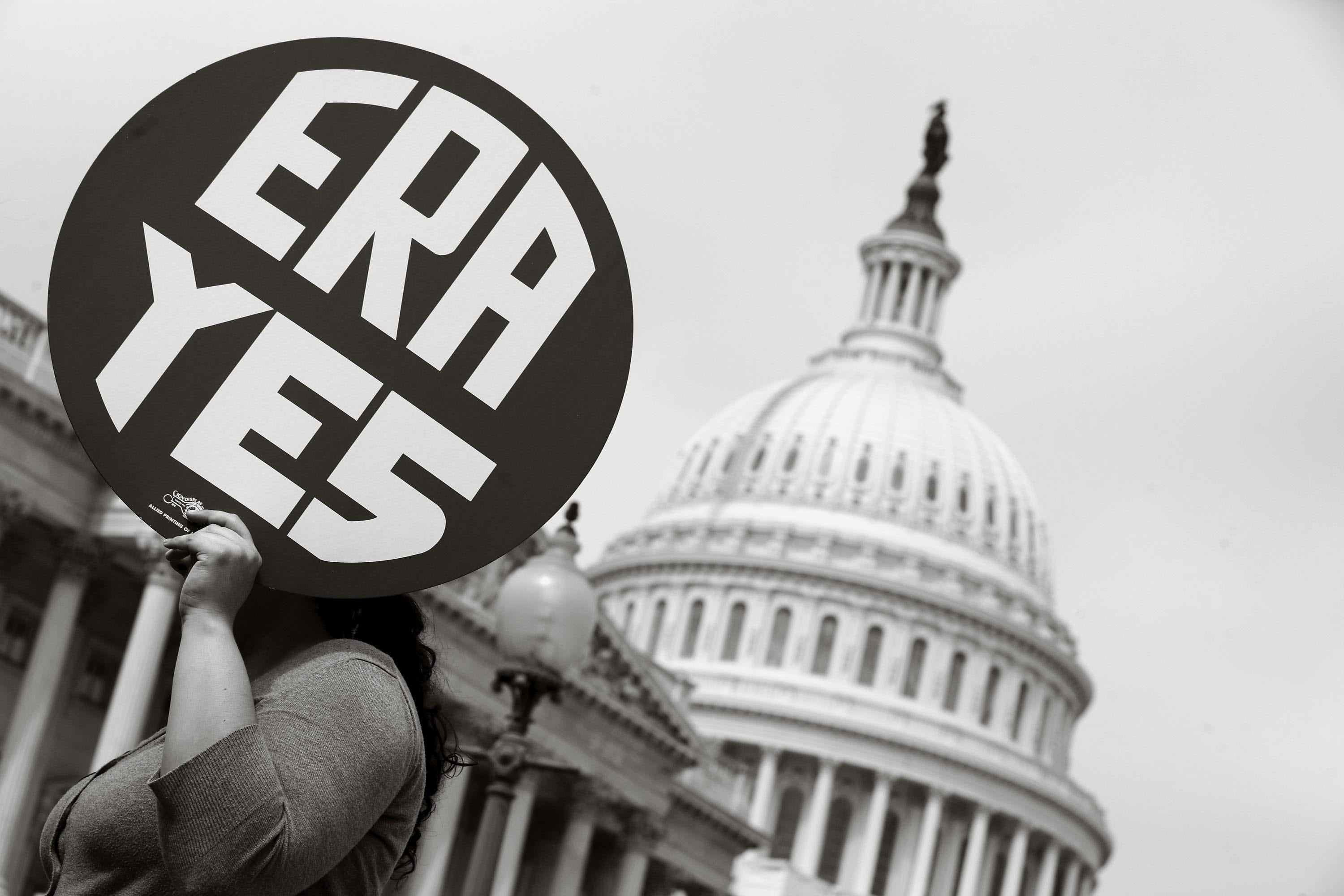 A woman holds up a sign as members of Congress and representatives of women's groups rally in 2012 to mark the 40th anniversary of congressional passage of the Equal Rights Amendment.