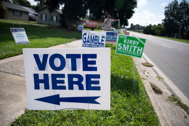 Signs line the entrance to a voting precinct in Eustis. [Cindy Peterson/Correspondent]