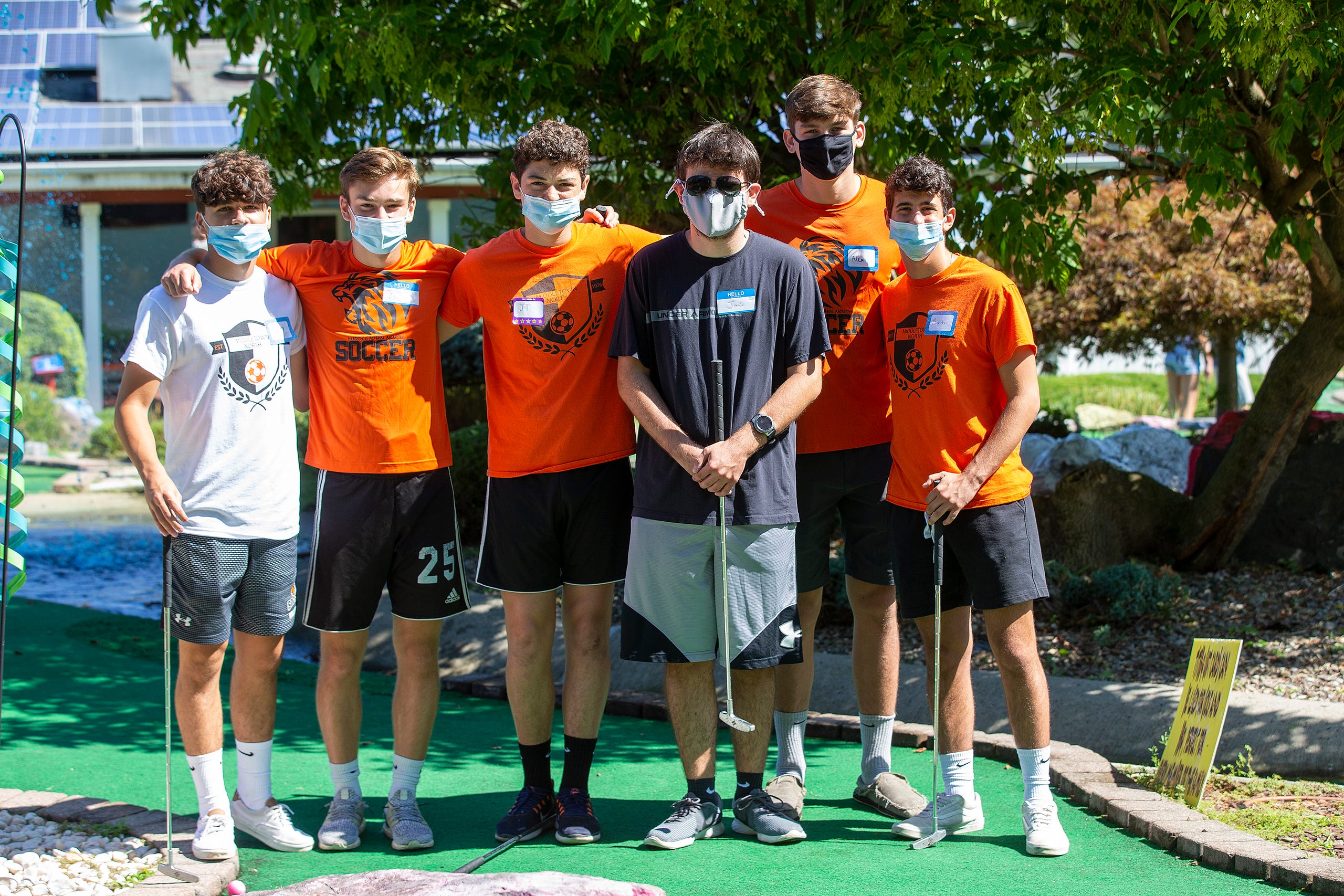 (back row) Members of the Middletown North boys varsity soccer team, Joey Vallillo, 17, Aidan Cardella, 17, JT Meredith, 17, Alex Bogues, 17and Brandon Del Grosso play mini-golf with (center) Joe Owens, 20 of Hazlet as part of Friends Connect Foundation, a nonprofit run by Sophia Ziajski, 19, of Middletown, at TST BBQ & Mini Golf in Middletown, NJ Tuesday, August 18, 2020.