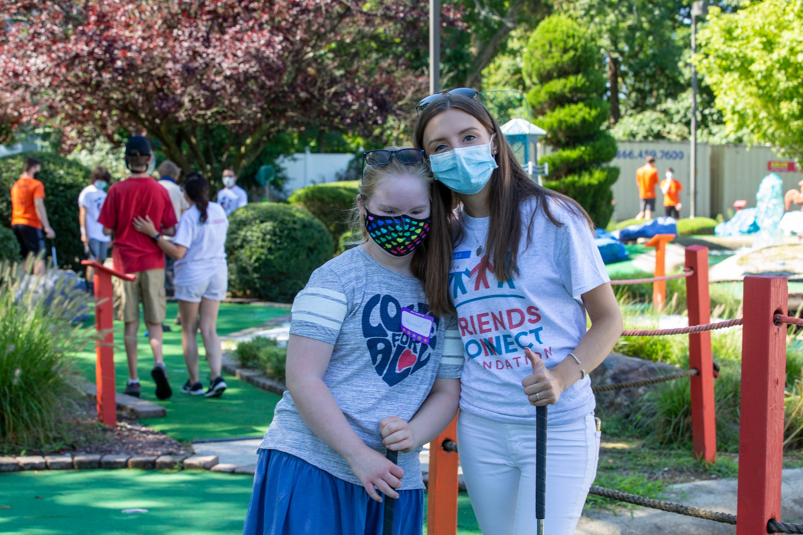 (right) Sophia Ziajski, 19, of Middletown, who runs the nonprofit Friends Connect Foundation, poses with Hannah Piasecki, 13, of Middletown as members of the Middletown North boys soccer team play mini-golf with a group of special-needs kids as part of Friends Connect Foundation at TST BBQ & Mini Golf in Middletown, NJ Tuesday, August 18, 2020.