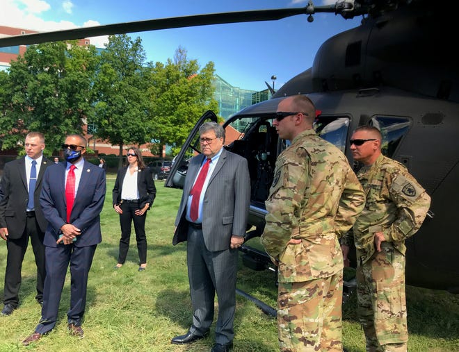 U.S. Attorney General William Barr, center, visits Detroit to help calm fears about the role of federal agents on August 18, 2020.
