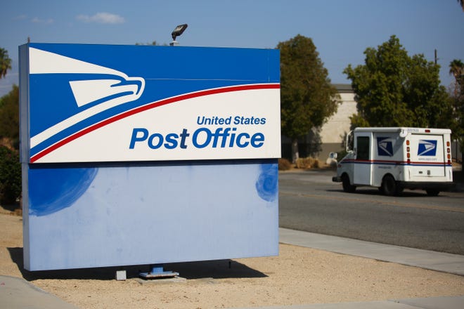 A U.S. Postal Service truck leaves a La Quinta post office on Tuesday, August 18, 2020, in La Quinta, Calif.