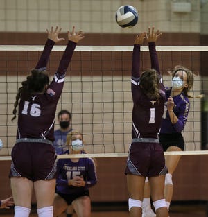 Bronte's Keeley Queen, left, and Katelyn Bohensky try to block a shot by Sterling City's Kate Barnes in a nondistrict volleyball showdown at Bronte High School on Monday, Aug. 17, 2020.