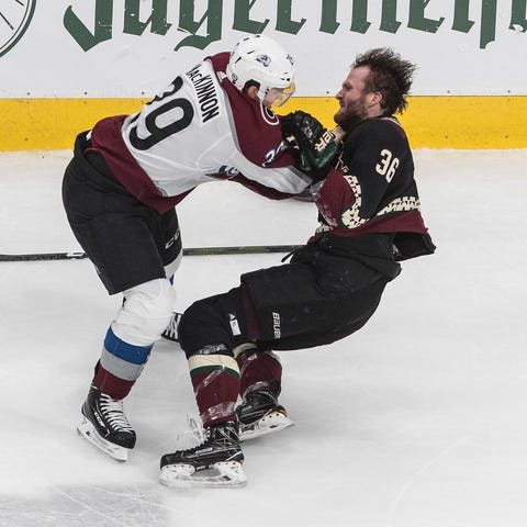 Colorado Avalanche's Nathan MacKinnon tussles with