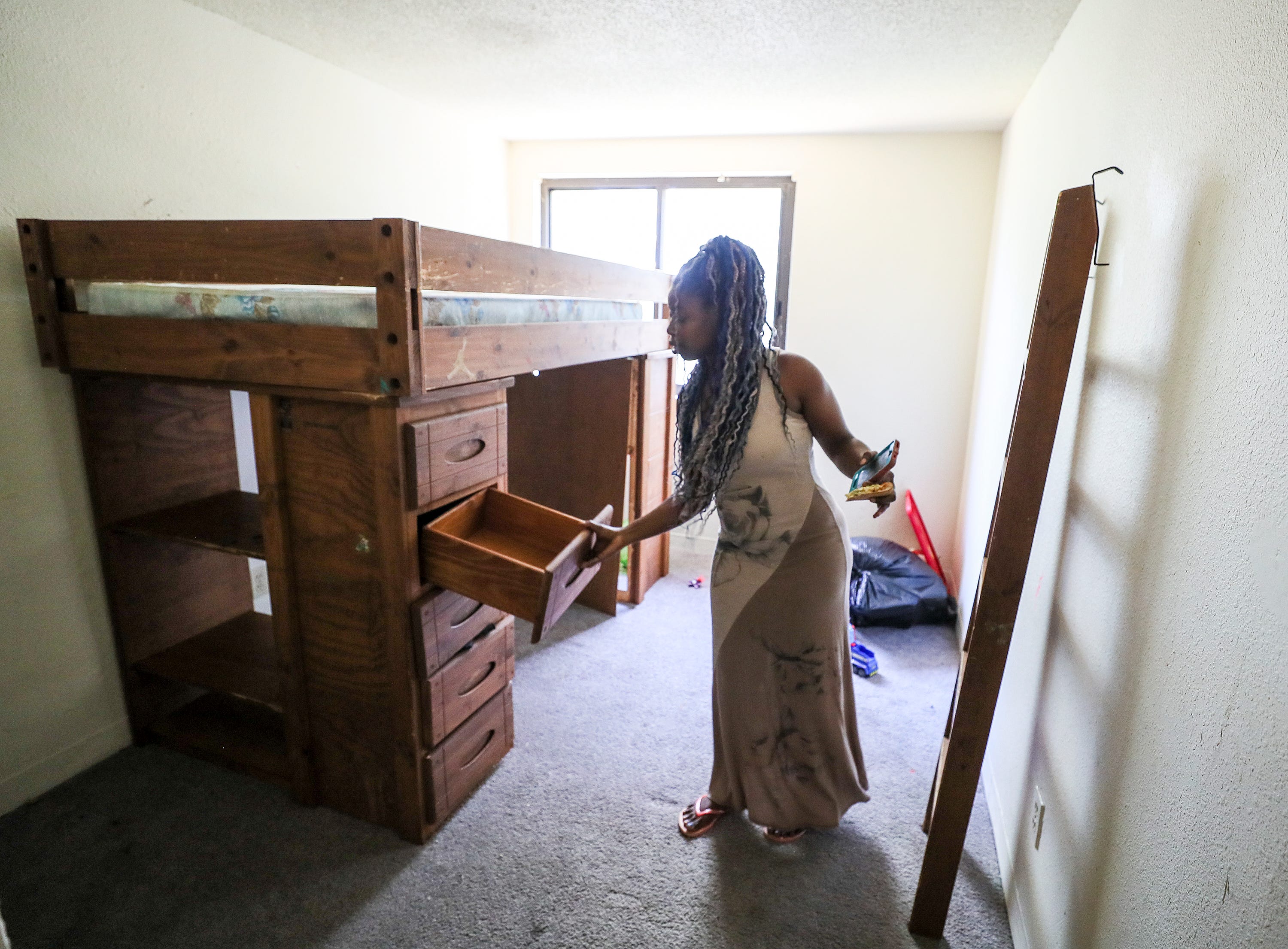 Kwmisha Adams shows the empty drawers in her sons' room.  Adams is being evicted from her apartment and preparing to leave. August 19, 2020