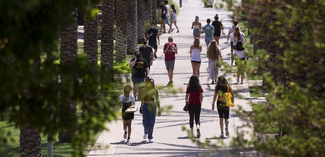 Students walk on campus the day before school opens on Aug. 19, 2020, at Arizona State University in Tempe.