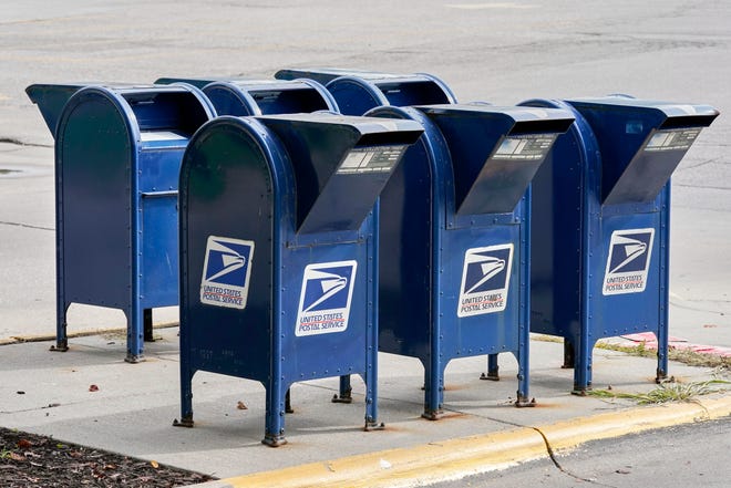 Mailboxes in Omaha, Neb., Tuesday, Aug. 18, 2020. The Postmaster general announced Tuesday he is halting some operational changes to mail delivery that critics warned were causing widespread delays and could disrupt voting in the November election. Postmaster General Louis DeJoy said he would "suspend" his initiatives until after the election "to avoid even the appearance of impact on election mail." (AP Photo/Nati Harnik)
